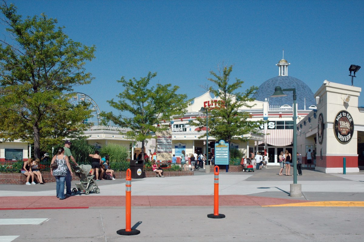 Theme park entrance sign and gate with visitors